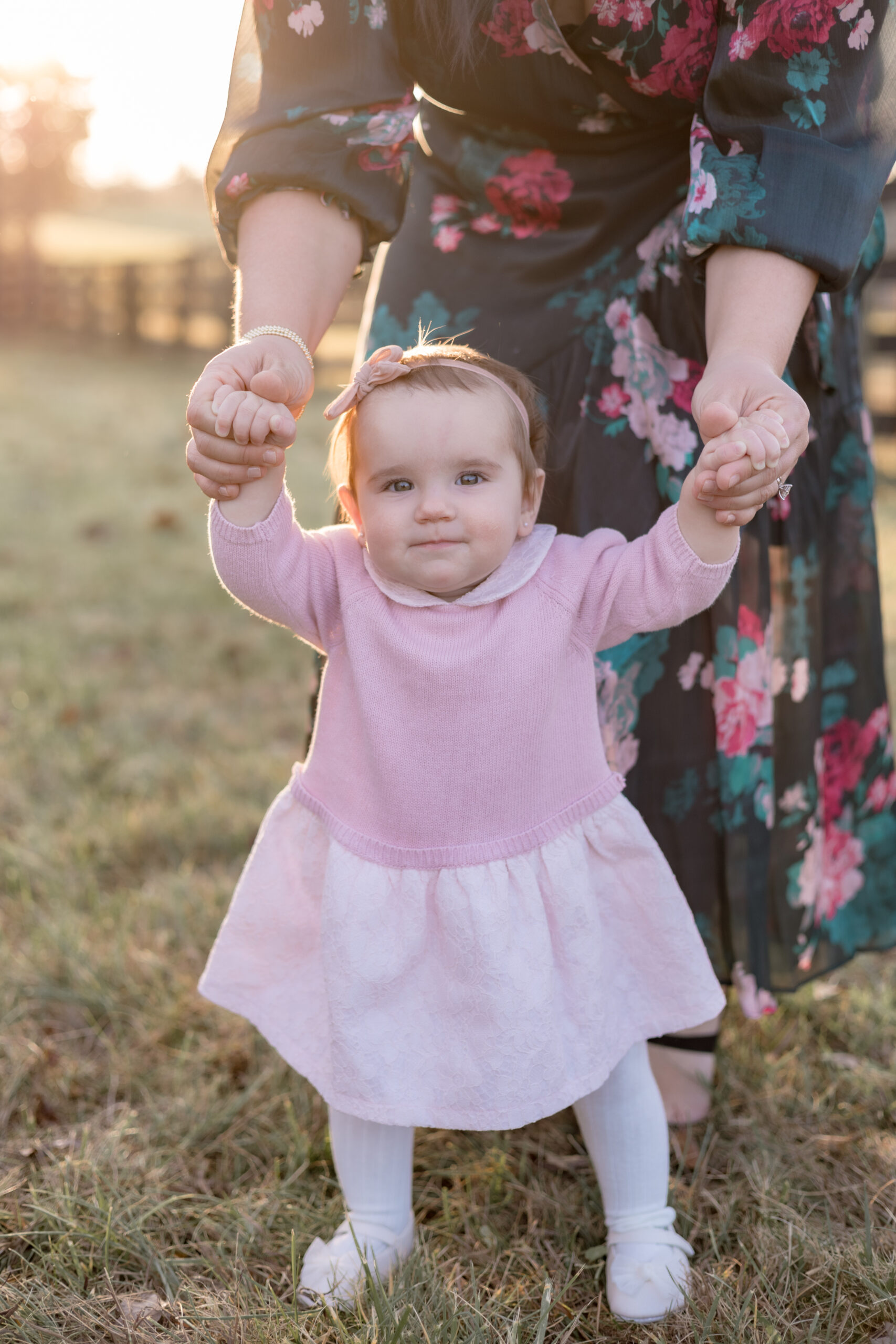 little girl in pink dress holding moms hands louisville family photographer